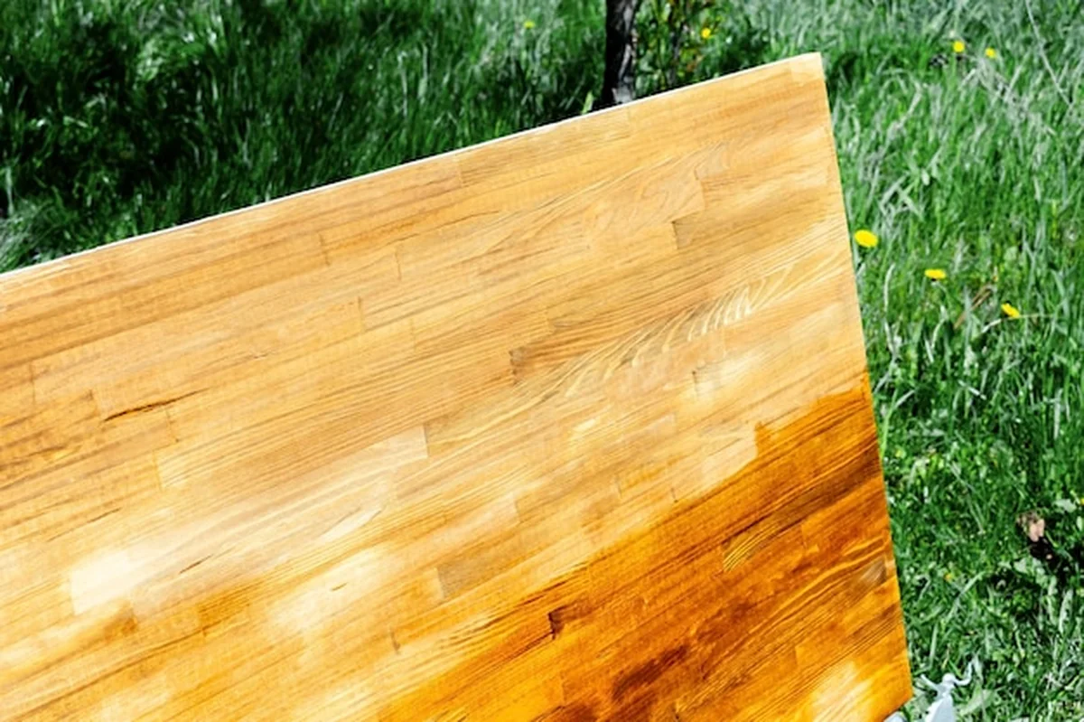 Nakładanie oleju na drewniany stół pędzlem podczas renowacji domu